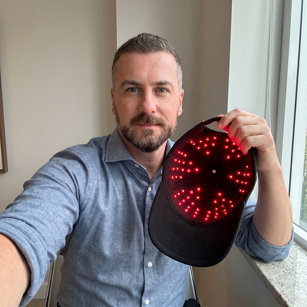 AI-generated illustrative scene: man holding a cap with illuminated red LEDs.